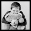 child hugging a teddy bear